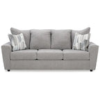 Szara tapicerowana sofa z rozchylonymi podłokietnikami