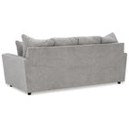 Szara tapicerowana sofa z rozchylonymi podłokietnikami